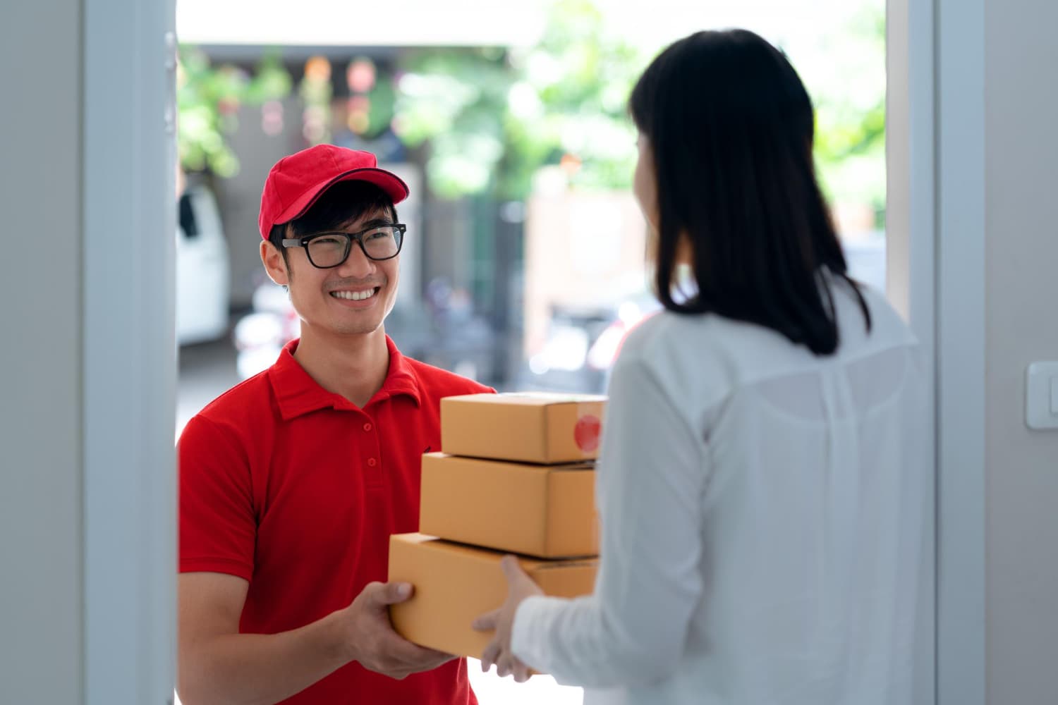 Delivery person handing packages to customer